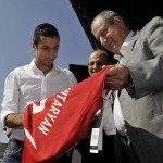 Henrikh Mkhitaryan signing a jersey to donate to Charity