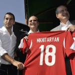 Henrkih Mkhitaryan, Dikran Tchablakian and Krikor Djabourian posing with the signed jersey